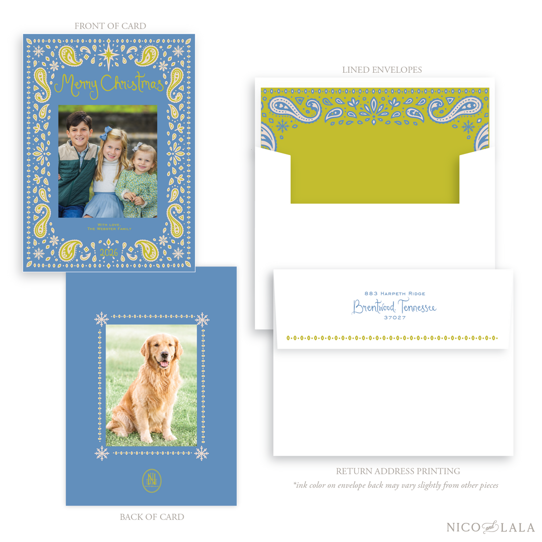 A Bandana print Christmas card and envelope set. The card is a periwinkle blue with a chartreuse paisley print where a customer uploads their own photo front and back. Envelope liners and return address are available as add ons. The card features chartreuse decorative text reading 'Merry Christmas'.